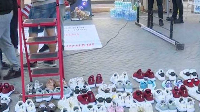 Citizens line up sneakers in front of the Prime Minister's Office, a symbol