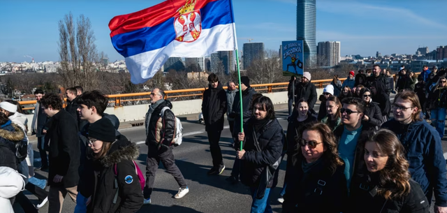 Serbian anti-government protesters block a key bridge in Belgrade