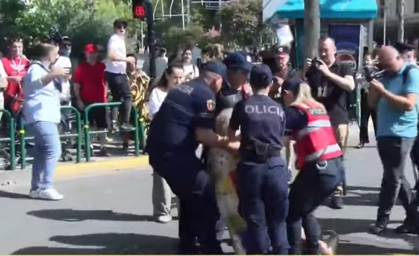 Photo/ Police drag an elderly man