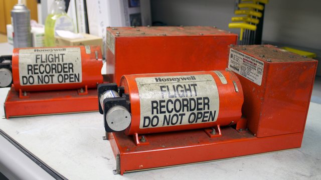 What does an airplane's black box look like and what does it contain?